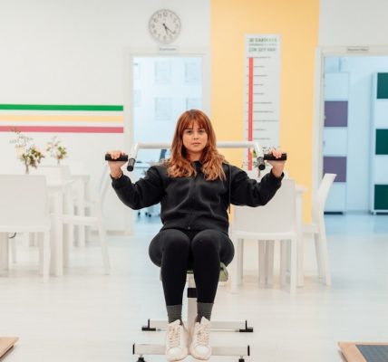 a woman sitting on top of a machine in a room