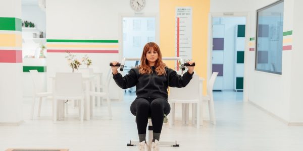 a woman sitting on top of a machine in a room